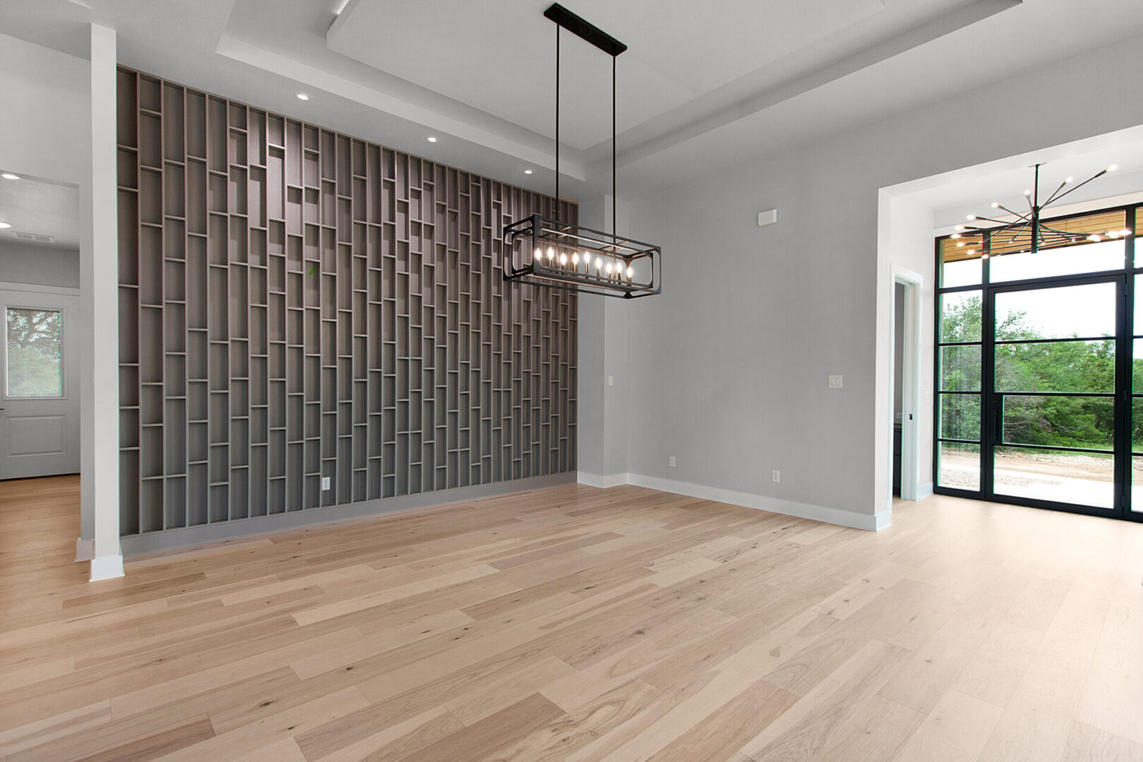 KCE HOMES Dining room, custom wine wall, wood floor metal door